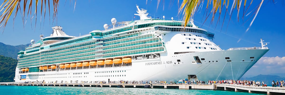 A docked Royal Caribbean cruise ship on crystal blue ocean