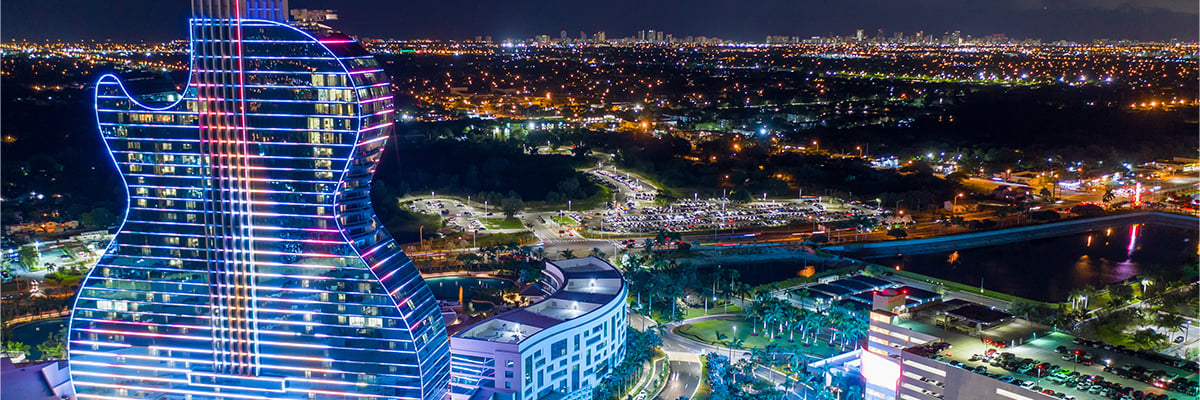 Aeried view of the guitar-shaped Hard Rock International hotel illuminated at night