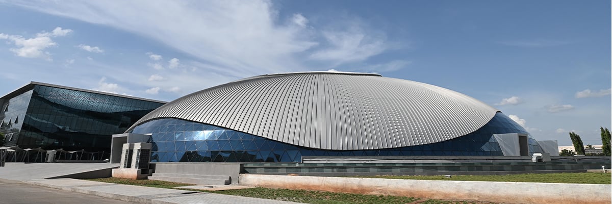 Outside view of the PSG Convention Center, a curved modern building