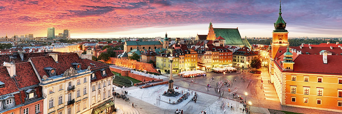 Aerial shot of a courtyard at Chopin University with a sun setting in the far background